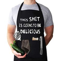 a man wearing an apron holding a cucumber and kitchen utensils in his hands