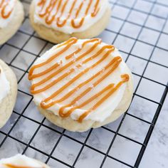 iced cookies with caramel drizzle and icing on a cooling rack