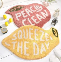 two door mats that say peace and clean with lemons on the floor next to them