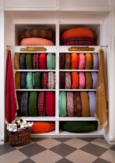 a closet filled with lots of different colored fabrics