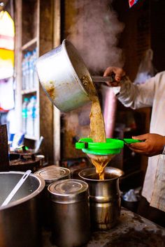 a person pouring something into some pots