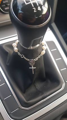 the interior of a car with a rosary and cross on it