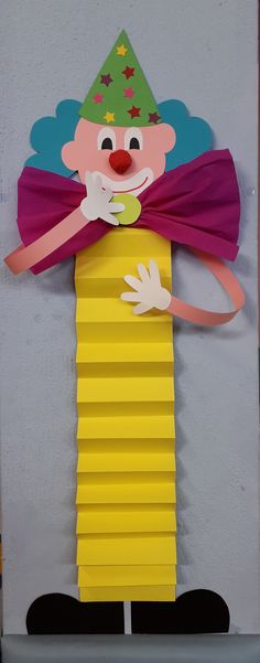 an image of a clown made out of construction paper on the side of a wall