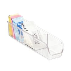 a clear plastic holder holds several different colored papers and pencils on a white background