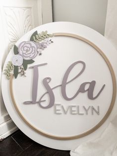 a white sign with flowers and the word is la evelyn on it's side