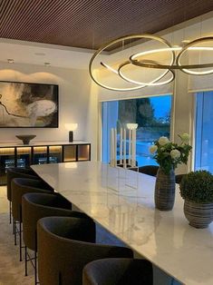 a large white counter top sitting under a chandelier