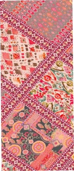 an old patchwork rug with many different colors and patterns on the surface, including pinks