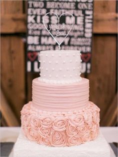 a wedding cake with white frosting and pink roses on the bottom is shown in an album