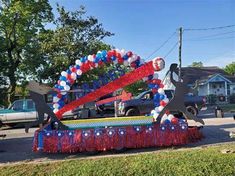 a parade float decorated with red, white and blue decorations