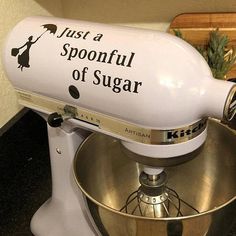 a kitchen aid mixer with the words just a spoonful of sugar on it