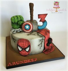 a spiderman birthday cake with the number 3 on it and an iron man figure