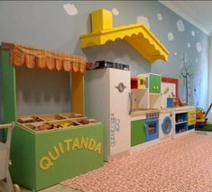 a child's play kitchen with toys on the floor