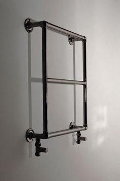 a black and white photo of a wall mounted towel rack with two bars on it