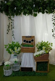 an arrangement of flowers and greenery on display