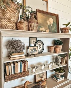 a book shelf with books and pictures on it