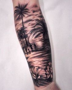 a man's arm with a palm tree and flowers on it