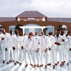 a group of men in white suits standing next to each other