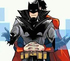 a man dressed as batman standing with his hands in his pockets and wearing a red cape