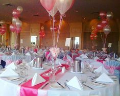 the tables are set with pink and white decorations, silverware, and champagne flutes