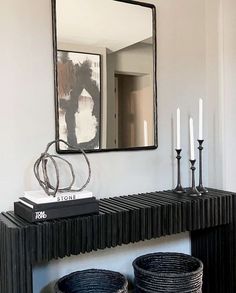 An entry table decorated with coffee table books, candles, baskets, and a medium sized mirror. Modern Entry Table, Cherry Blossom Branches, Abstract Vase, Entry Table Decor, Flower Branches, Console Table Styling, Black Console Table, Entry Design, Entryway Table Decor