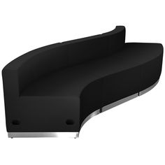 a black curved couch sitting on top of a white floor