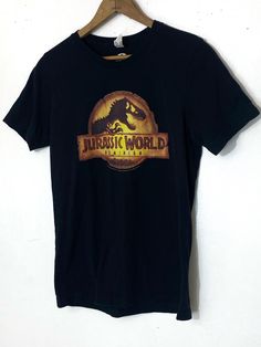 "Official Jurassic World T-shirt size Adult small 17\"x26\"" Jurrasic World, Vintage Teddy Bears, Cute Jackets, Almost Perfect, World Domination, Philadelphia Pa, Jurassic World, Navy Pants, Hoodie Design