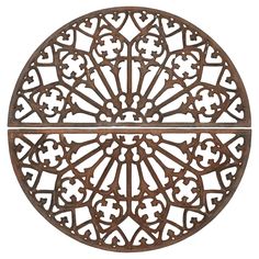 an iron circular wall decoration with crosses and hearts on the center, set against a white background