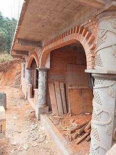 an old brick oven is being built on the side of a building that's under construction