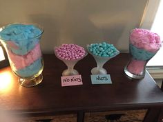 three vases filled with candy sitting on top of a table