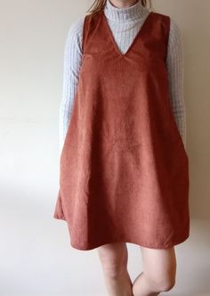 The Autumn Dress is a short length dress with a deep V neckline and bust darts. It's sleevless, with pockets and widens as it goes down for a flowy, comfortable, unrestricted feel. It looks great on it's own or layered with a tee or jumper underneath and leggings/tights and boots! A really versatile dress!  Handmade in North-East England, made with 100% repurposed fabric. Every item is handcrafted from scratch using fabric previously destined for landfill, including second-hand: fabric, table linen, curtains. As well as deadstock fabric and remnants/offcuts. The range is determined by repurposed fabric so there was are small numbers of each pattern. Dress With Turtleneck Underneath, Dress With Turtleneck, Repurposed Fabric, Deadstock Fabric, Fabric Table, Tights And Boots, Handmade Dress, Dress Handmade, Autumn Dress