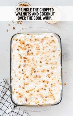 a casserole dish with white cream and chopped walnuts