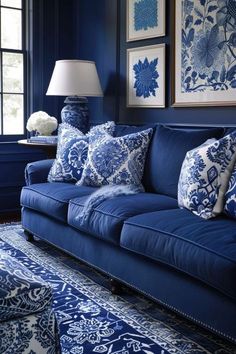 a living room with blue couches and pictures on the wall above them in shades of blue