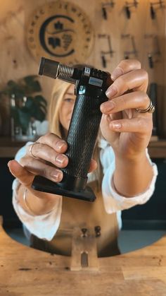 a woman holding up a lighter in front of her face