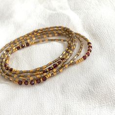 Garnet bracelet seed bead stretch wrap bracelet Birthstone | Etsy Adjustable Bohemian Rondelle Beaded Bracelets, Bohemian Stretch Bracelet With Tiny Beads As Gift, Bohemian Stretch Bracelet With Tiny Beads, Bohemian Rondelle Beaded Bracelets For Gifts, Bohemian Rondelle Beaded Bracelets As Gift, Adjustable Hand Wrapped Beaded Bracelets, Adjustable Hand Wrapped Beaded Bracelets For Layering, Bohemian Tiny Beads Bracelets For Meditation, Bohemian Beaded Bracelets With Flexible Round Beads