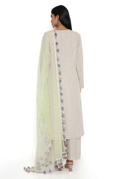 Cream straight kurta in linen base with floral embroidery. Paired with a palazzo and lime green dupatta.
Components: 3
Pattern: Embroidered
Type Of Work: Thread
Neckline: Round V
Sleeve Type: Three-quarter
Fabric: Linen, Net
Color: Cream,Green
Other Details: 
Length:
Kurta: 48 inches
Pant: 42 inches
Model Height: 5ft 8inches, wearing size M
Disclaimer: Since the designer is a made-to-measure brand and the dyeing process and embroidery are handcrafted, there may be slight variations in the color Elegant Linen Set With Resham Embroidery, Spring Linen Kurta With Resham Embroidery, Spring Embroidered Slub Silk Sets, Spring Floral Embroidery Raw Silk Palazzo Set, Elegant Embroidered Linen Sets, Elegant Linen Sets With Floral Embroidery, Linen Chikankari Embroidery Wedding Sets, Festive Linen Kurta With Embroidered Border, Wedding Linen Kurta With Resham Embroidery