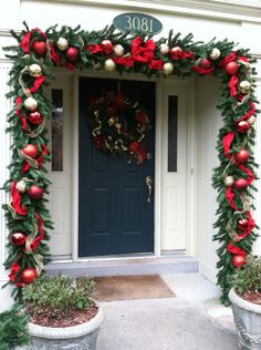 the front door is decorated with christmas decorations