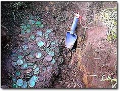 a shovel sitting on the ground next to some coins