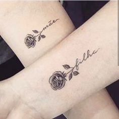 two people with matching tattoos on their arms, one is holding the other's arm