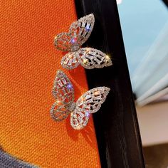 How charming are these crystal butterflies. Available in Silver and gold finish. These dazzling pieces are enough to make your charm outshine! 🌟Minimal & Aesthetic. 🌟Light weight and comfortable! 🌟 They are versatile, both the color variations glow different. 🌟All items come in a box and bubble mailers for extra protection. 💎Message me for Bulk pricing Do peep at our other earrings and items from our shop! 👇👇👇 You have a great taste✨ Thank you for stopping by🙏 See you soon👋💕 Crystal Butterflies, Gold Diamond Earrings Studs, Angel Earrings, Aesthetic Light, Angel Wing Earrings, Crystal Butterfly, Swarovski Stones, Minimal Aesthetic, Small Earrings Studs