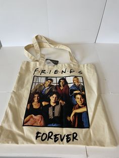 a tote bag with the words friends forever printed on it, sitting on a white surface