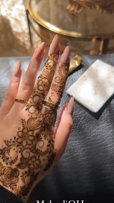 a woman's hand with henna on it