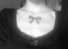 a woman with a bow tattoo on her chest