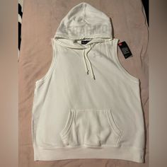 Solid White Color Sleeveless Hoodie W/ Kangaroo Pocket, Brand New Hooded Vest Top For Streetwear, White Cotton Workout Vest, Casual Cotton Workout Vest, White Athleisure Tank Top For Streetwear, Sleeveless Hoodie For Streetwear, Casual Hooded Tank Top For Sports, Sleeveless Hoodie For Streetwear In Athleisure Style, Casual Sleeveless Hoodie For Workout, Casual Cotton Sports Vest