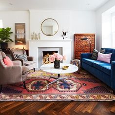 a living room with two couches and a fire place in it's center