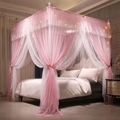 a pink canopy bed in a bedroom with lights on the ceiling and curtains over it