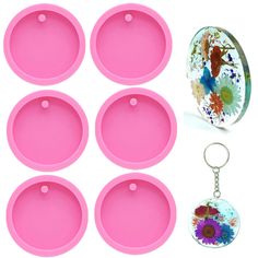 six pink trays with keychains and flower designs on them, one has a round mirror in the middle