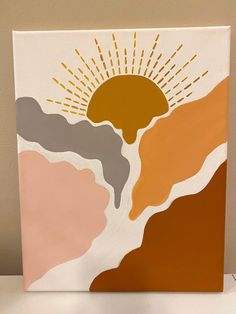 an abstract painting with sun and mountains in the background on a white table next to a brown wall