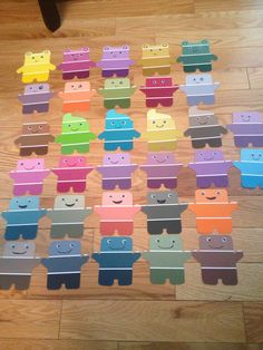 a group of cut out animals sitting on top of a wooden floor