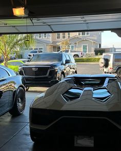 some very nice looking cars parked in a garage