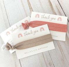 two personalized hair ties on top of each other with the words thank you written on them